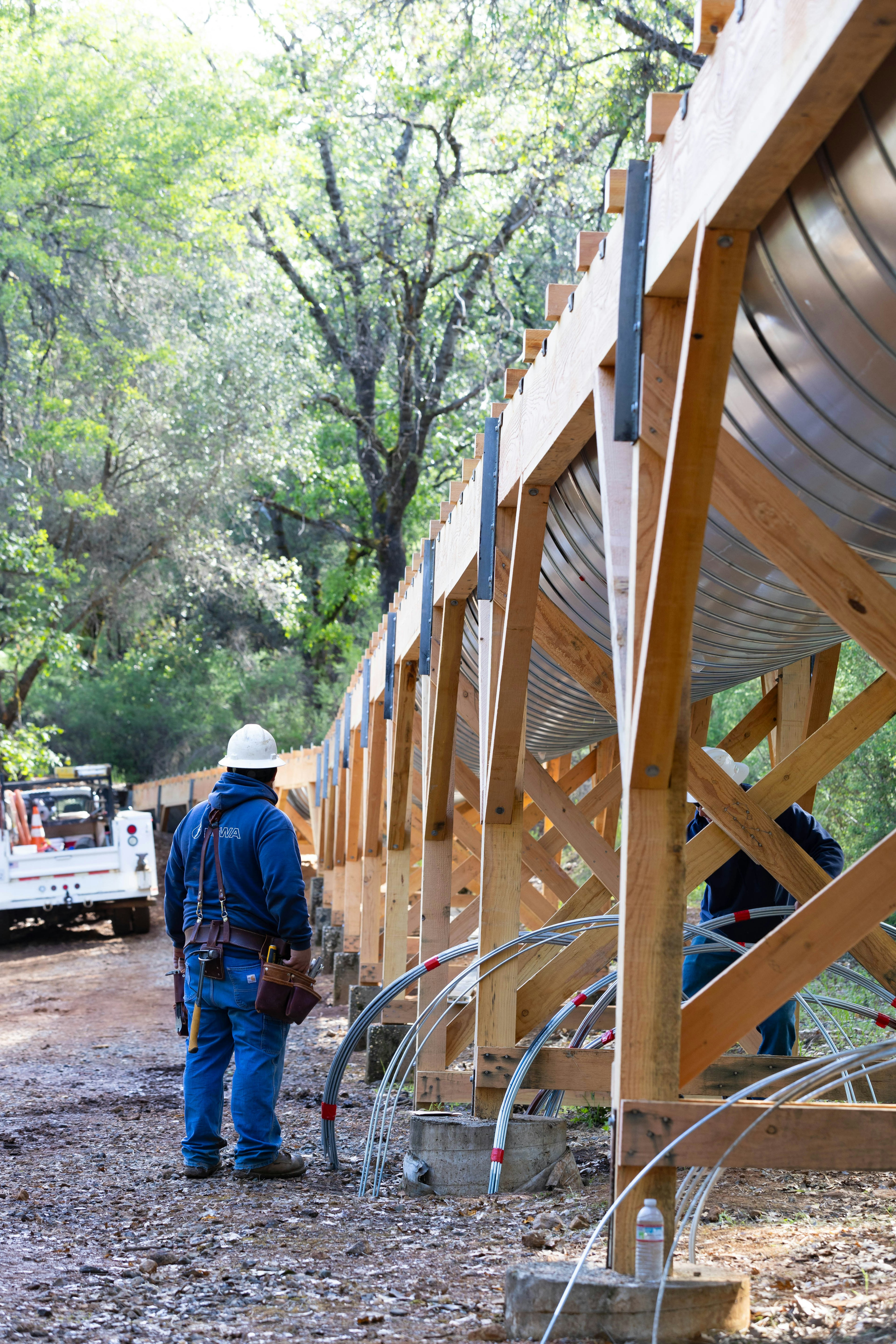 Photo of PCWA employee standing near a flume under construction