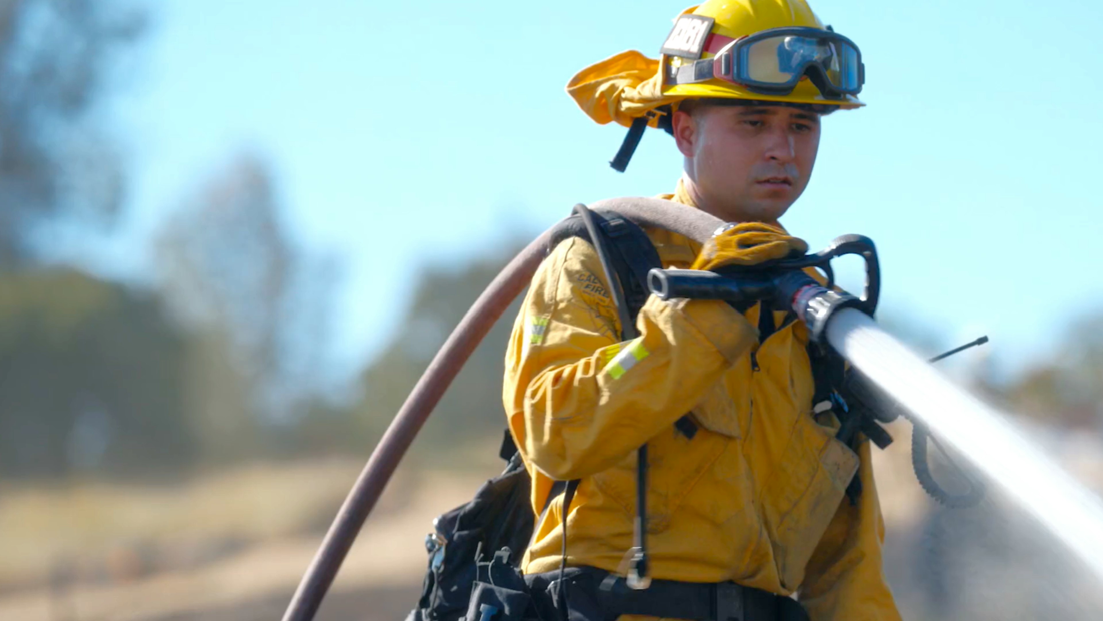 Firefighter with hose over shoulder